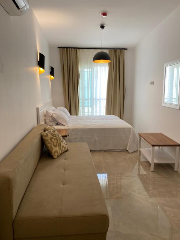 a living room with a bed and a couch at Amber Boutique Hotel in Cesme