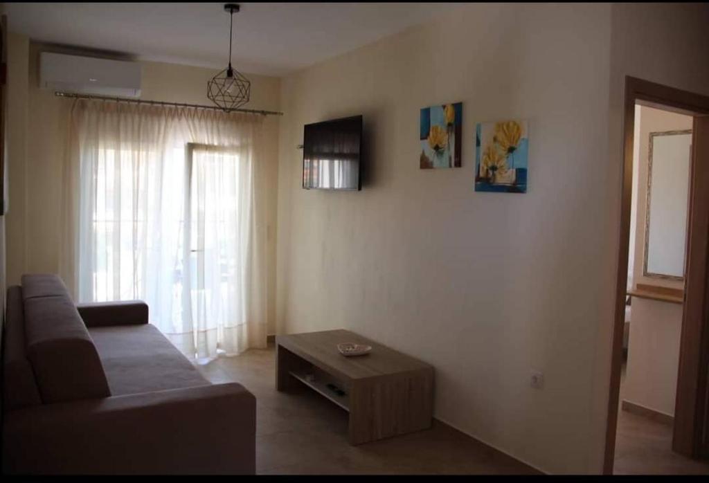 a living room with a couch and a coffee table at Xanthiotis Apartments in Skala Rachoniou