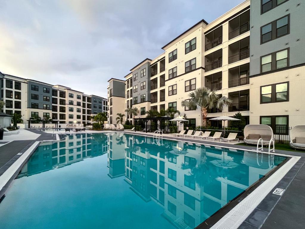 a swimming pool in front of some apartment buildings at Westshore Apartments by Barsala in Tampa