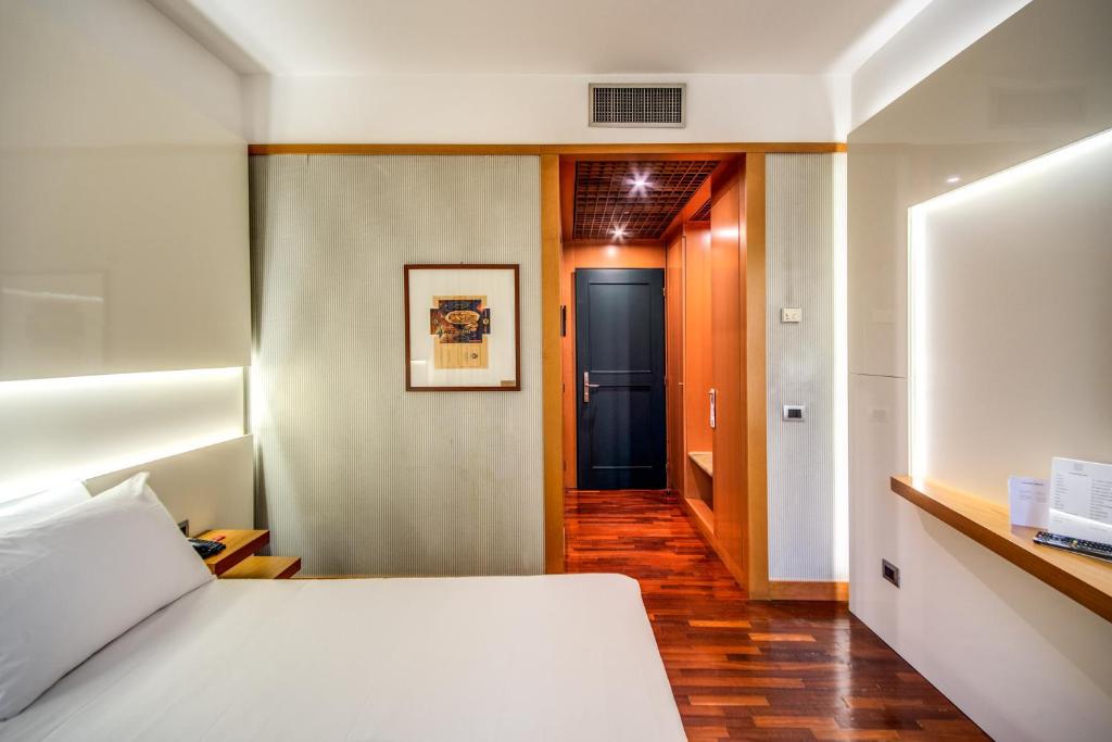 Łóżko lub łóżka w pokoju w obiekcie Hotel Della Rotonda