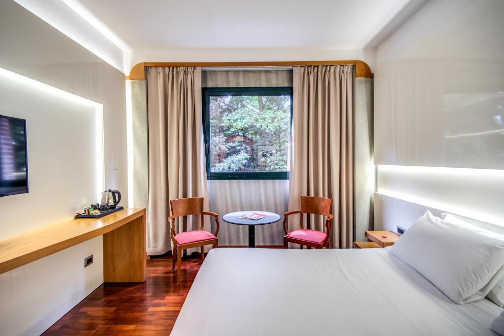 Łóżko lub łóżka w pokoju w obiekcie Hotel Della Rotonda