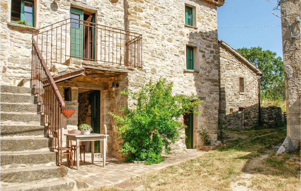 a stone house with a staircase and a table at 1 Bedroom Gorgeous Apartment In Villagrande Di Monteco 