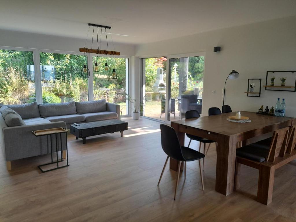 a living room with a table and a couch at Haus EDDA - Ferienwohnungen mit Garten und Schlossblick in Marburg an der Lahn