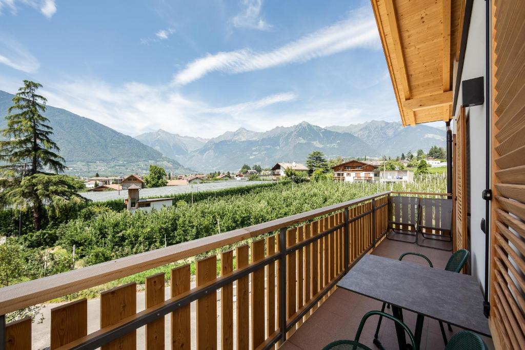 a balcony with a bench and a view of mountains at Torgglbauer Apartment 3 in Merano