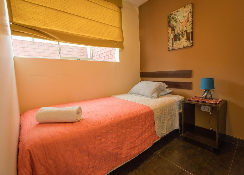 Postel nebo postele na pokoji v ubytování B&B Wasi Airport Lima