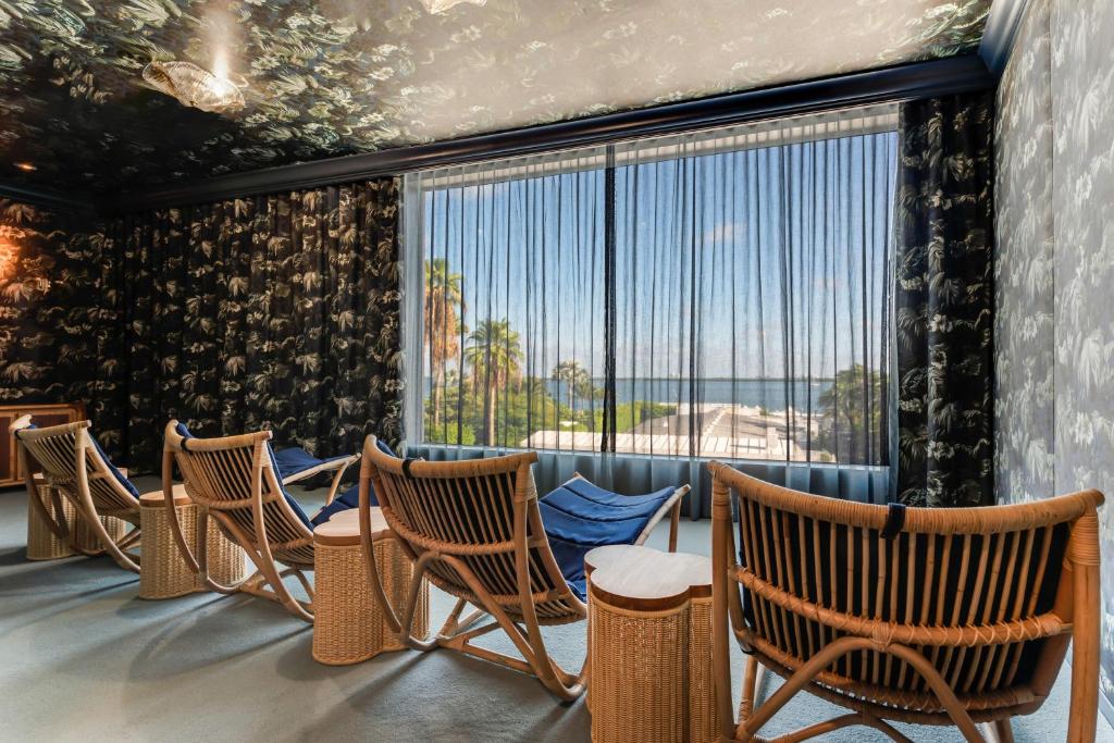 a row of chairs in a room with a large window at The Standard Miami in Miami Beach