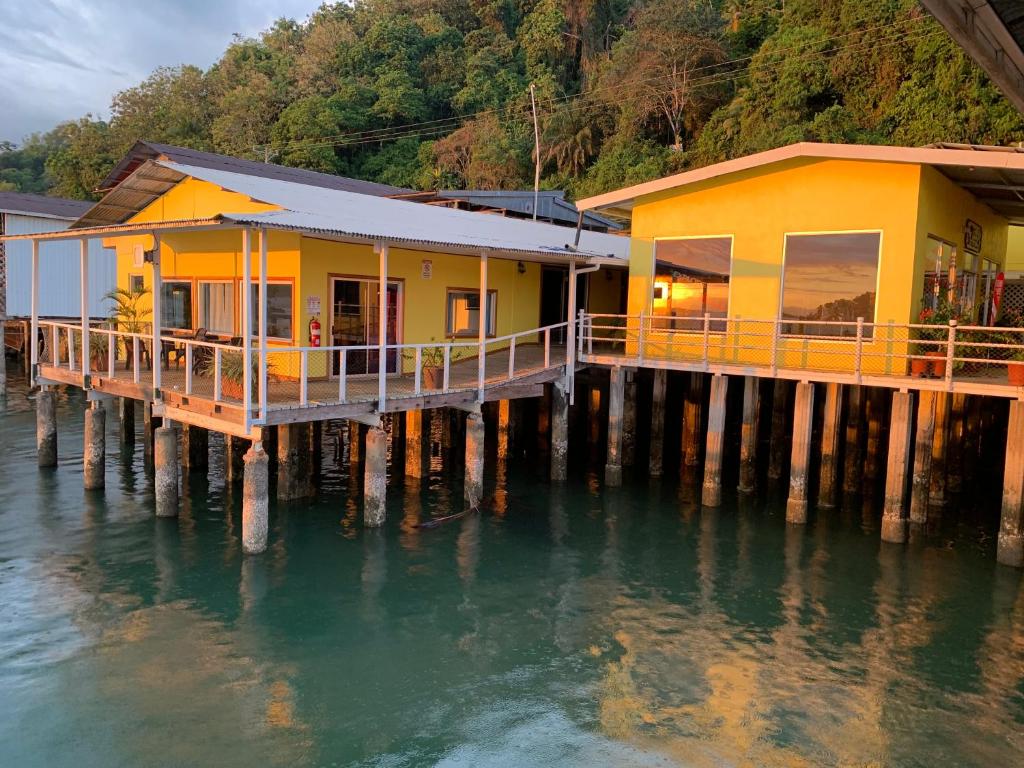 a house on a dock in the water at Banana Bay Marina in Golfito