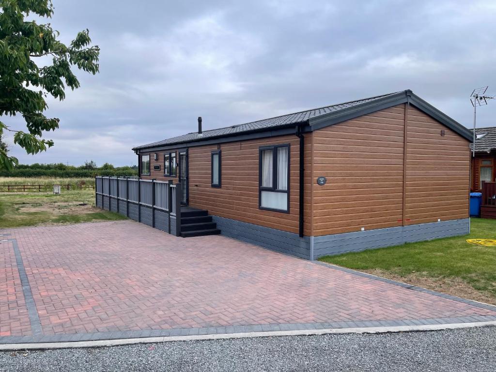 a modular house with a brick driveway at Yorkshire view lodge in York