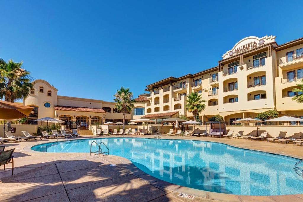 a large swimming pool in front of a hotel at The Murieta Inn and Spa in Rancho Murieta