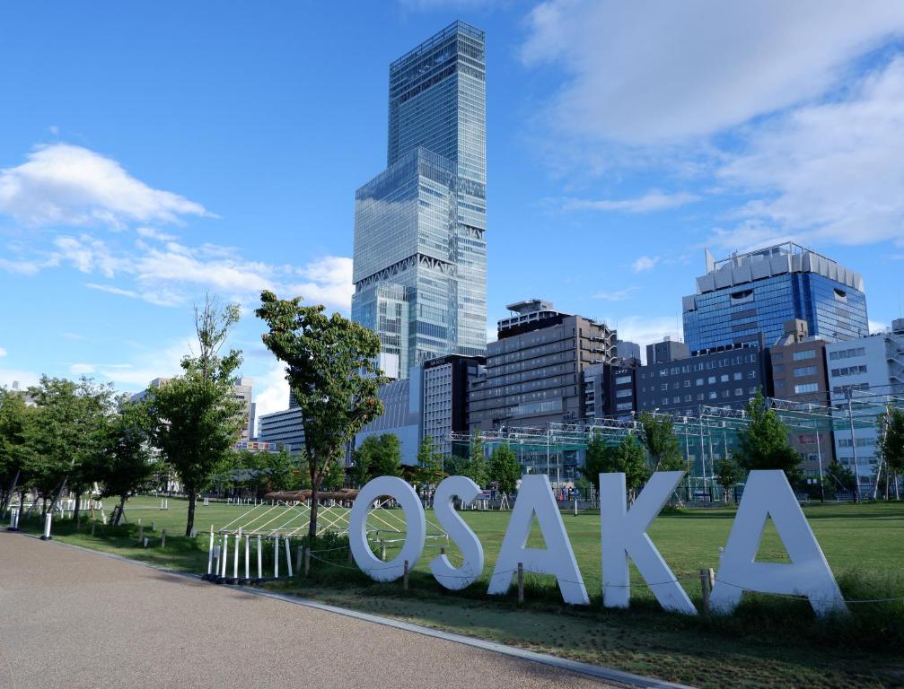 a sign in a park in front of a city at Osaka Marriott Miyako Hotel in Osaka