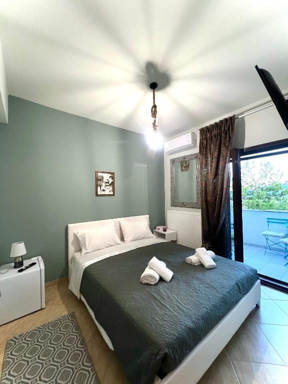 a bedroom with a bed with two towels on it at Villa Kastro Elassona in Elassona