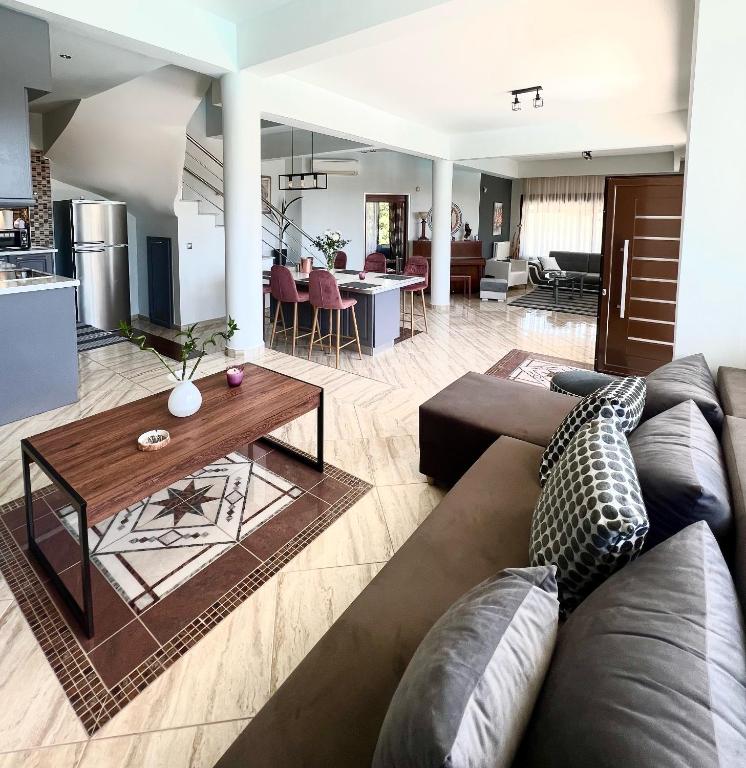 a living room with a couch and a table at Villa Kastro Elassona in Elassona