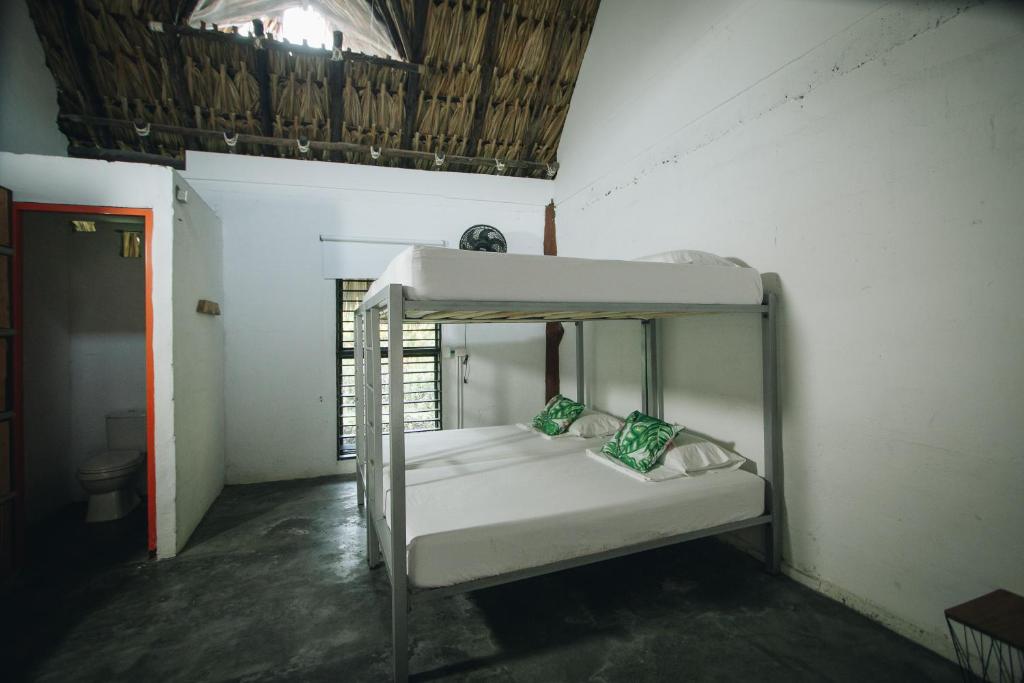 Postel nebo postele na pokoji v ubytování Makenke Hostel By Los Colores Ecoparque