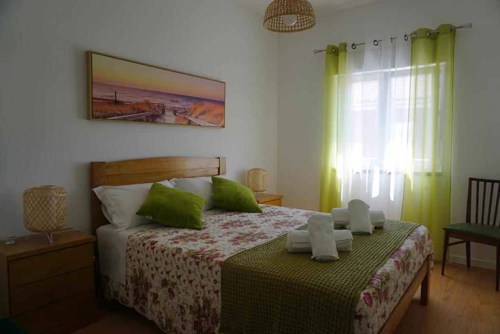 a bedroom with a bed with two towels on it at Portela House - T3 Residential home 50 meters from the beach in Vila Praia de Âncora