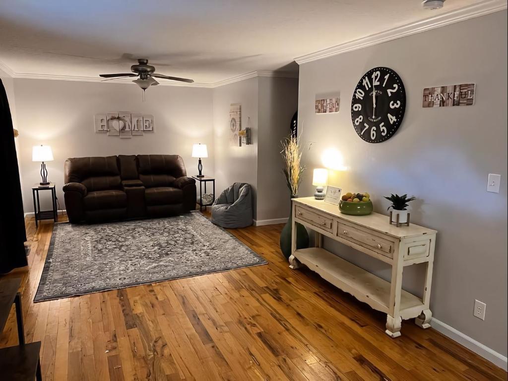 a living room with a couch and a table at Kid-Friendly Townhouse Near Lake & Sports Complex in Guntersville