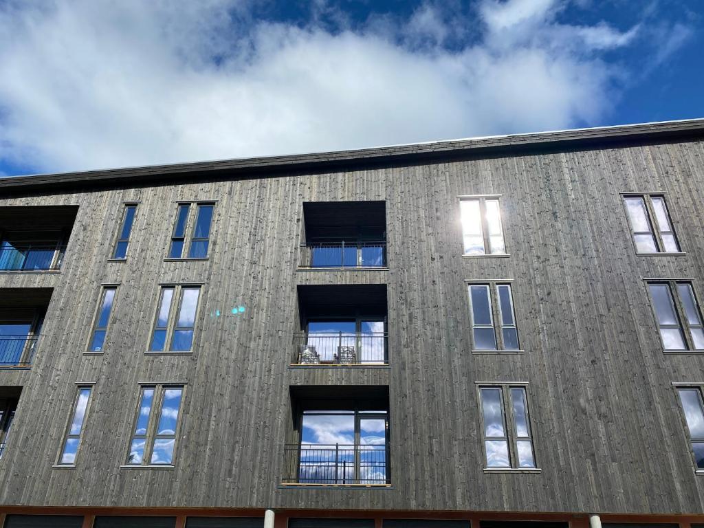a brick building with windows on the side at New apartment, Gausta in Rjukan. Ski in/ ski out in Rjukan