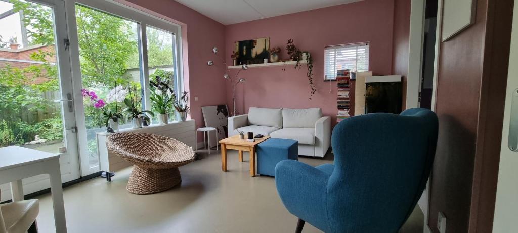 a living room with two chairs and a couch at Lovely 1 bedroom apartment with garden in Amsterdam