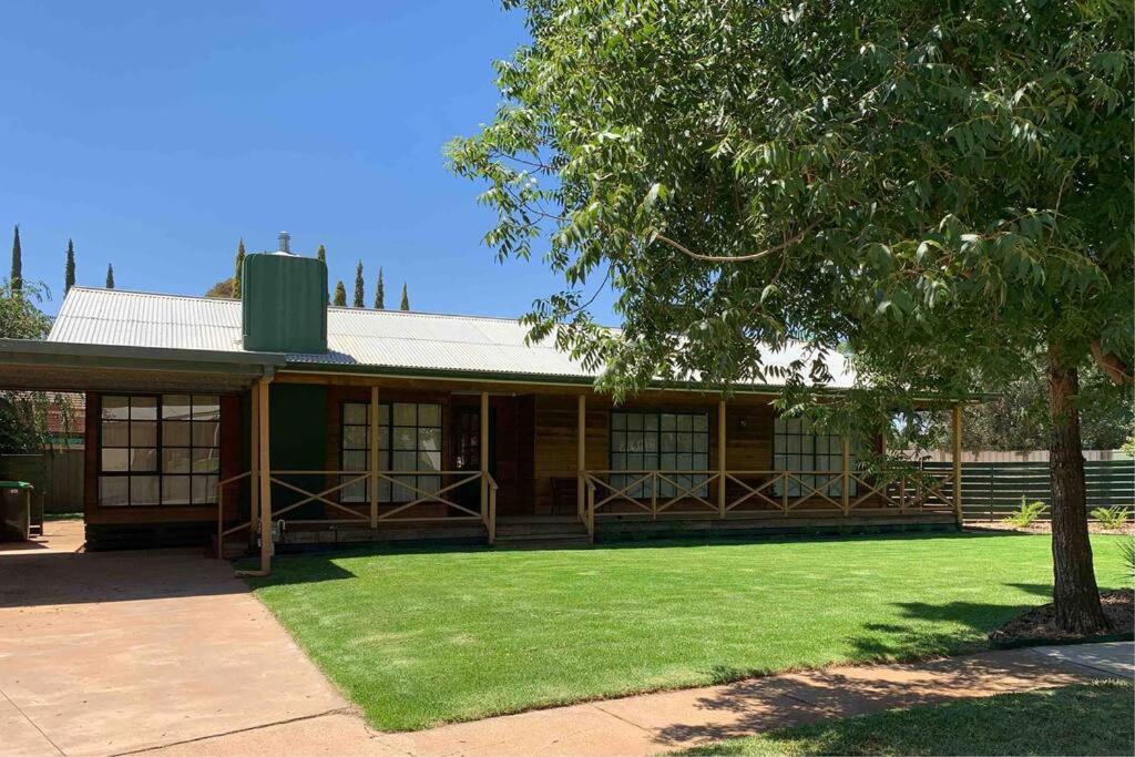 a house with a green lawn in front of it at The Cottage in Mildura