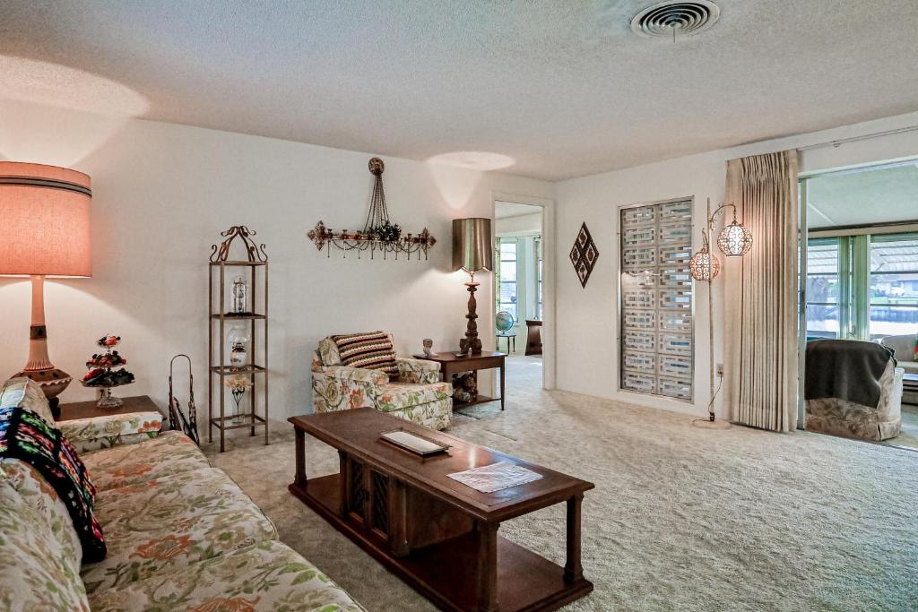 a living room with a couch and a table at Tarpon Lagoon in Port Charlotte