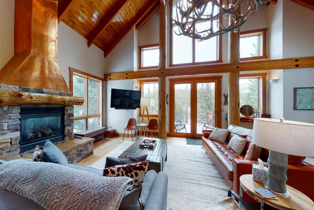 a living room with a couch and a fireplace at Boondoggle Basin in Big Sky