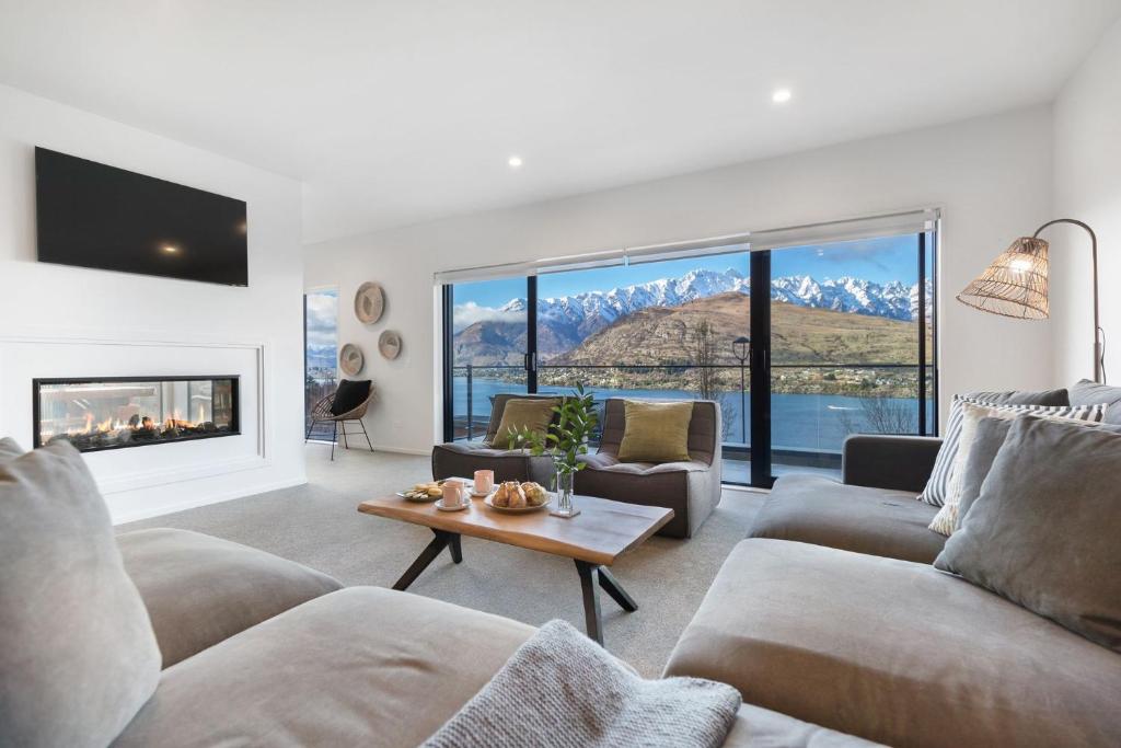 a living room with a couch and a fireplace at St Matthews Views Walter in Queenstown