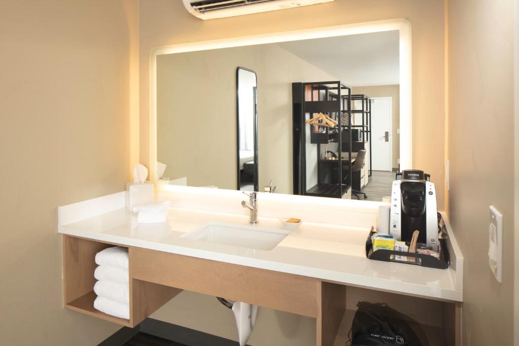 a bathroom with a sink and a large mirror at Waypoint Hotel in Bend