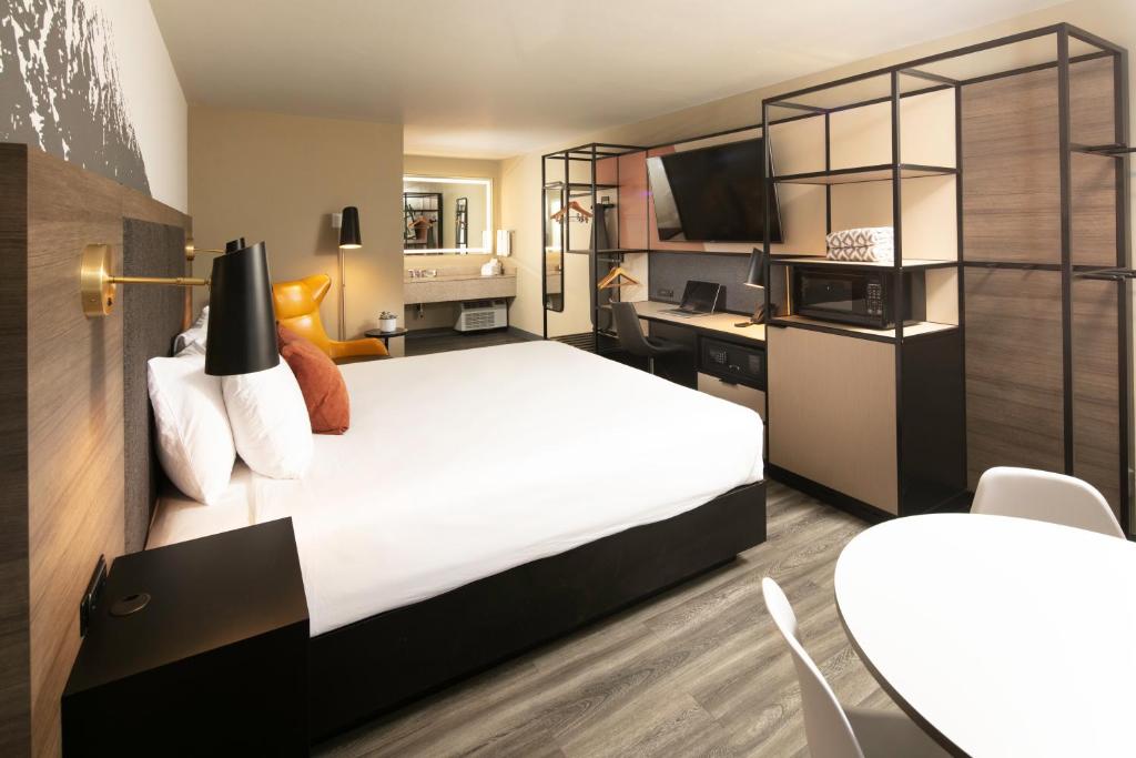 a hotel room with a large bed and a desk at Waypoint Hotel in Bend