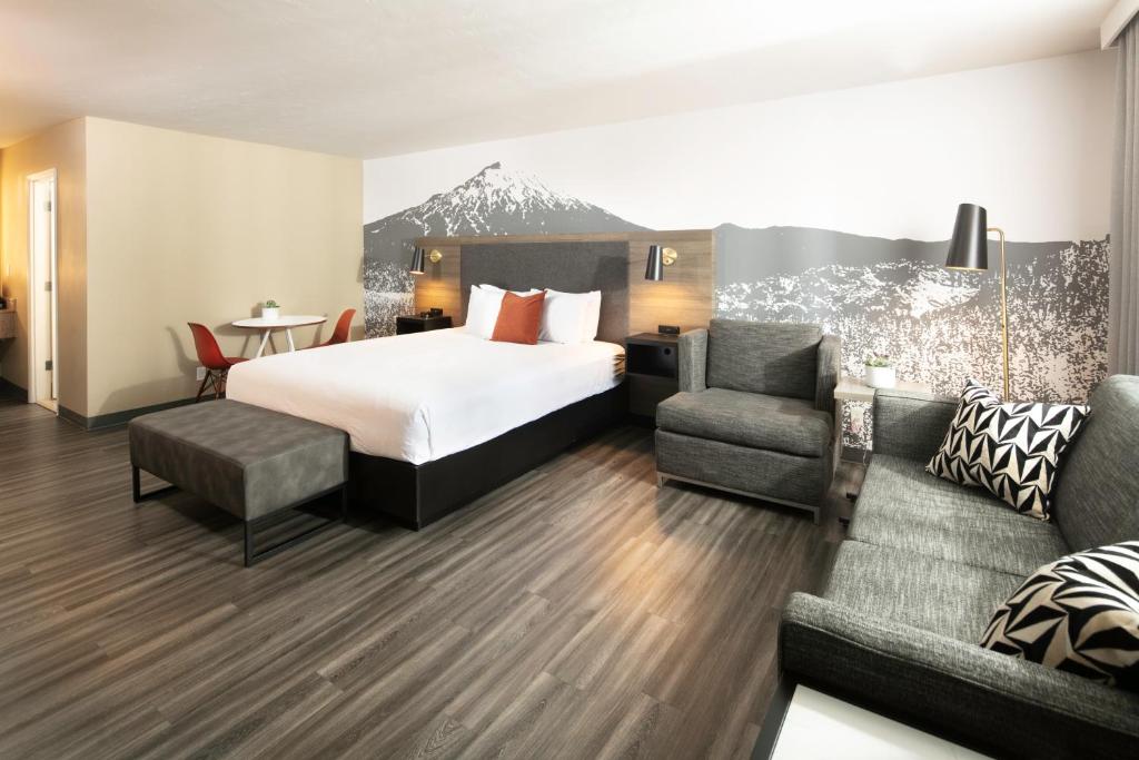 a hotel room with a bed and a couch at Waypoint Hotel in Bend