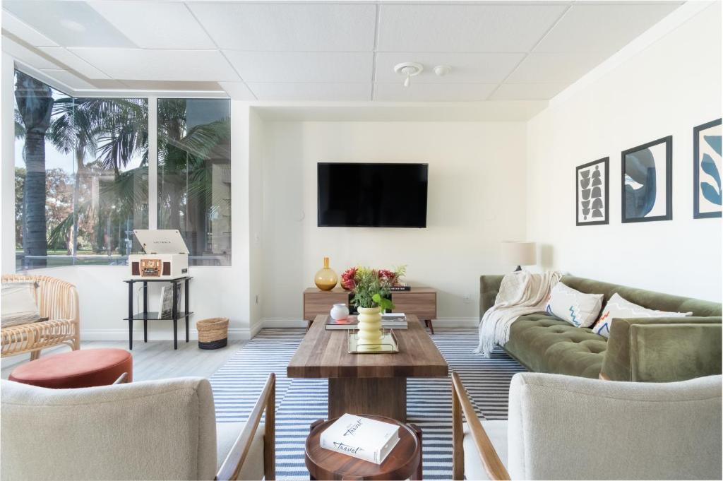 a living room with a couch and a table at Balboa II by AvantStay Modern Condo w Balcony Views of Balboa Park in San Diego