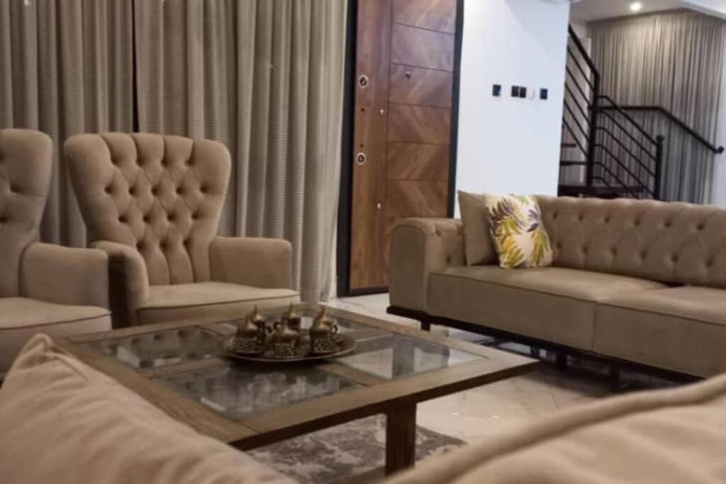 a living room with two couches and a coffee table at Vista Lakeside Villas Akosombo in Oko Sombo