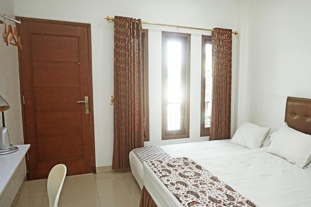 Postel nebo postele na pokoji v ubytování Andelis Homestay