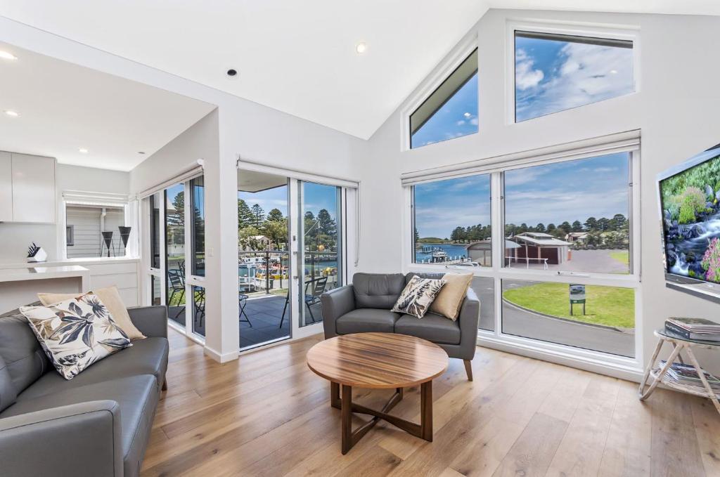 a living room with a couch and a table at Absolute in Port Fairy