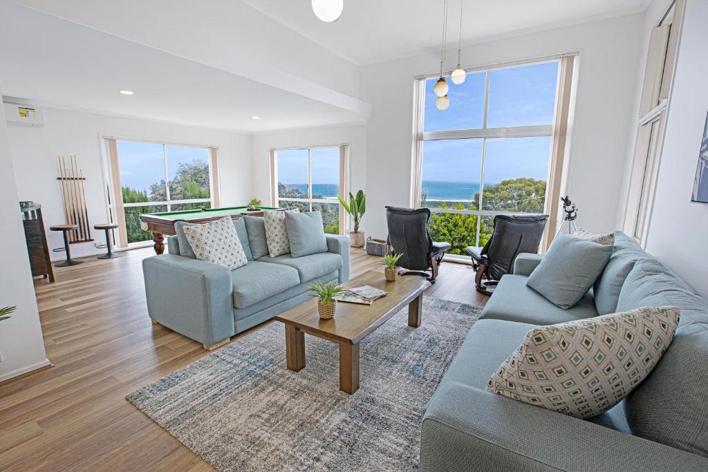 a living room with two couches and a table at Sea Haven in Lakes Entrance