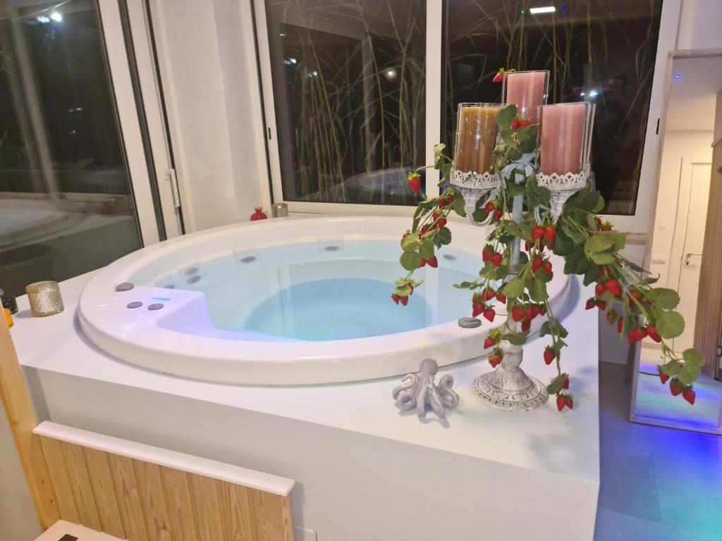 a jacuzzi tub in a bathroom with a window at Ulivi di Minerva - Boutique Holiday Home - SUPER SUITE & SPA POLLON - Ostuni - Fasano - Cisternino in Montalbano