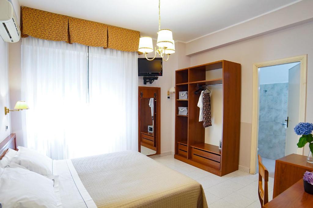 Cama ou camas em um quarto em Hotel Marconi