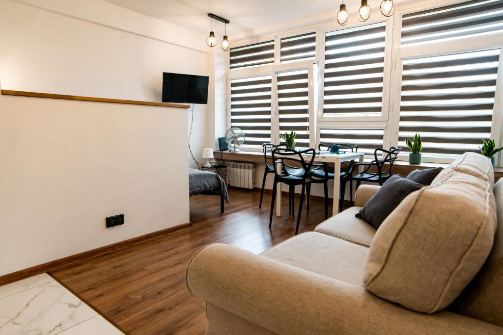 a living room with a couch and a table at Komfortowy apartament ścisłe centrum Radom in Radom