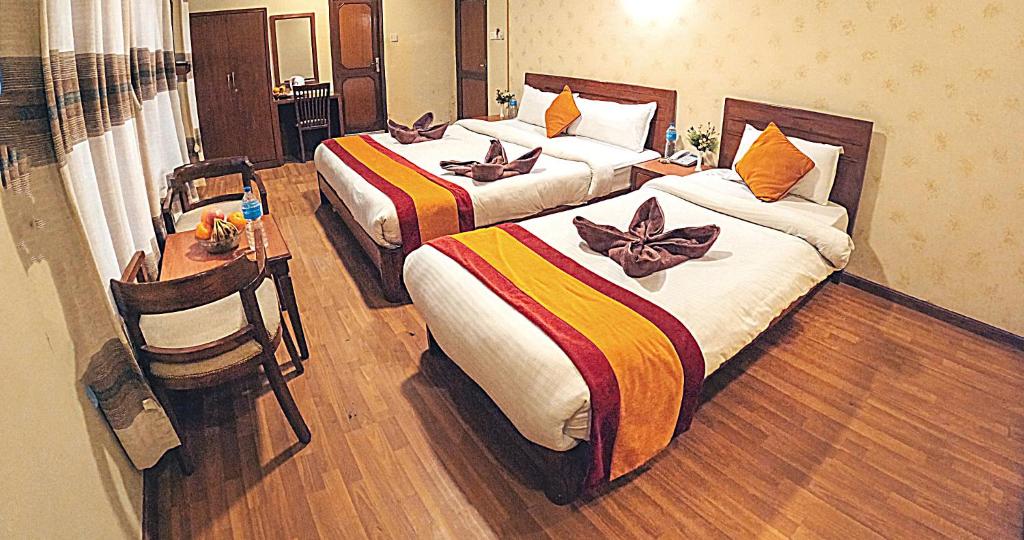 Postel nebo postele na pokoji v ubytování Royal Kings Hotel