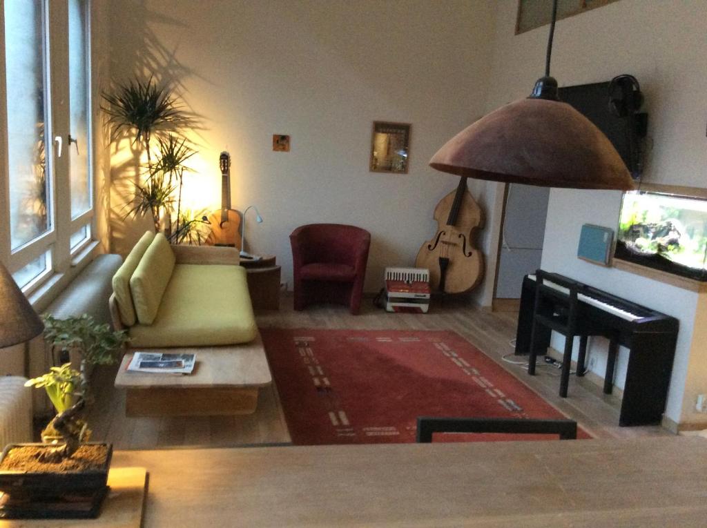 a living room with a couch and a guitar at Historical center Antwerp, all on foot in Antwerp