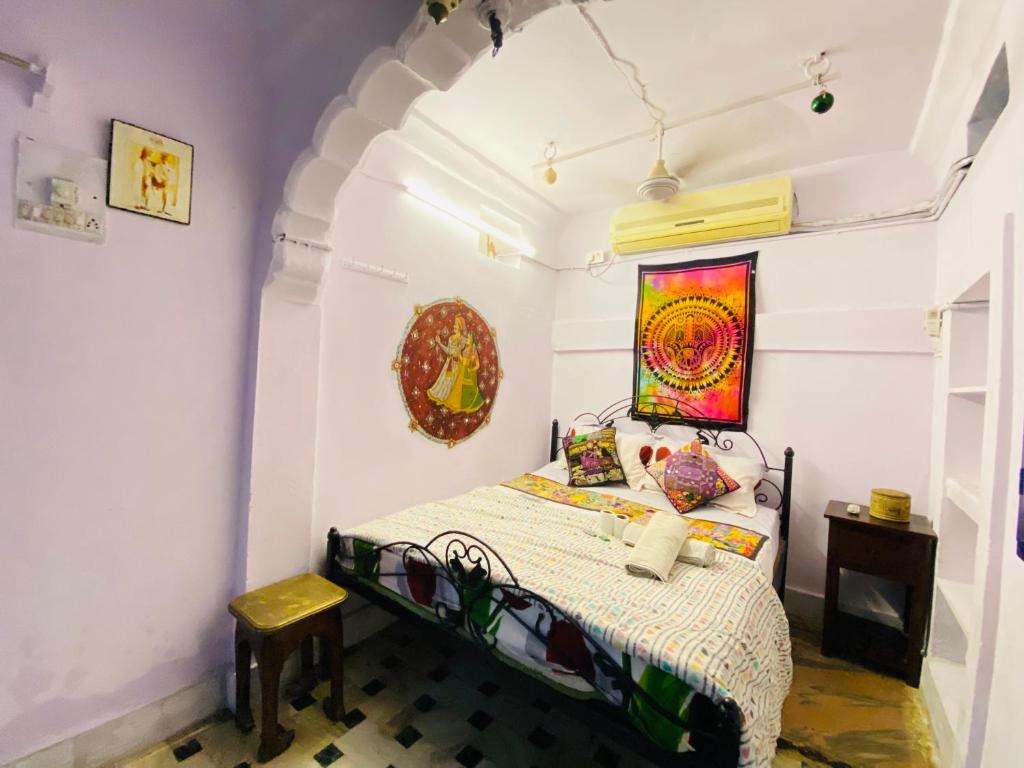 a bedroom with a bed and a painting on the wall at Bob hostel in Jodhpur