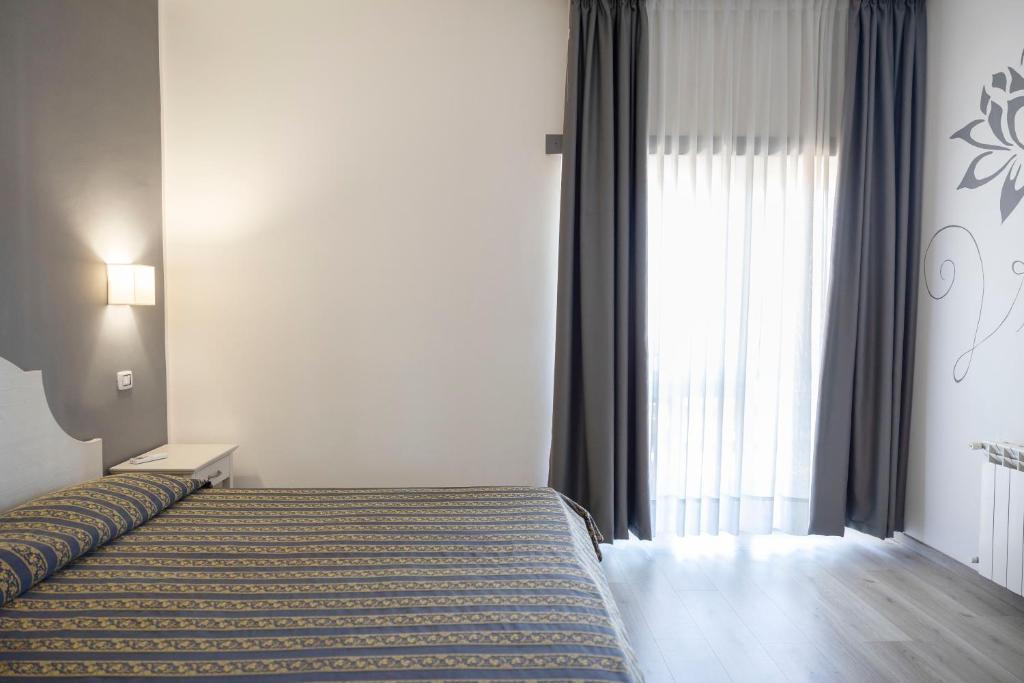 Postel nebo postele na pokoji v ubytování Hotel Villa Margherita