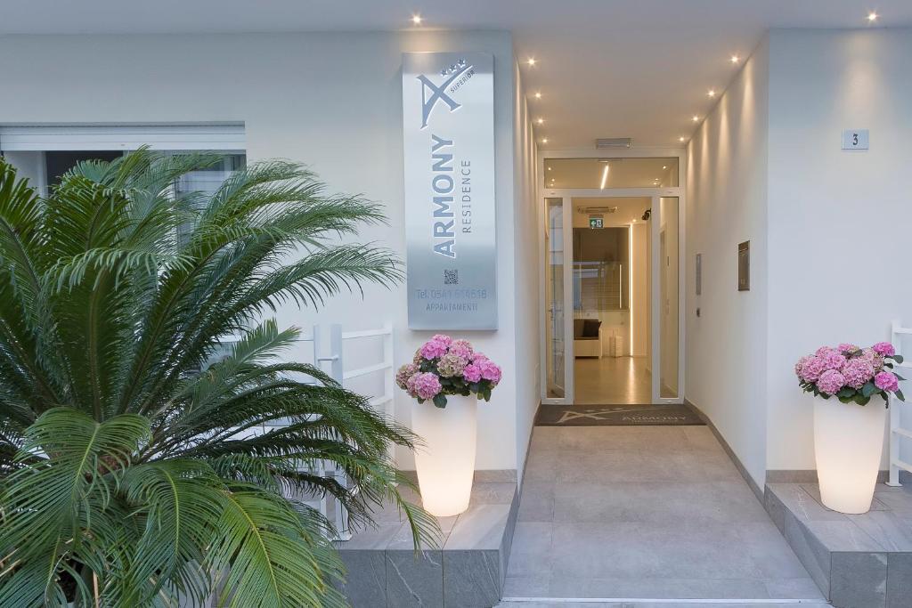 a lobby with two potted plants on the wall at Residence Armony in Misano Adriatico