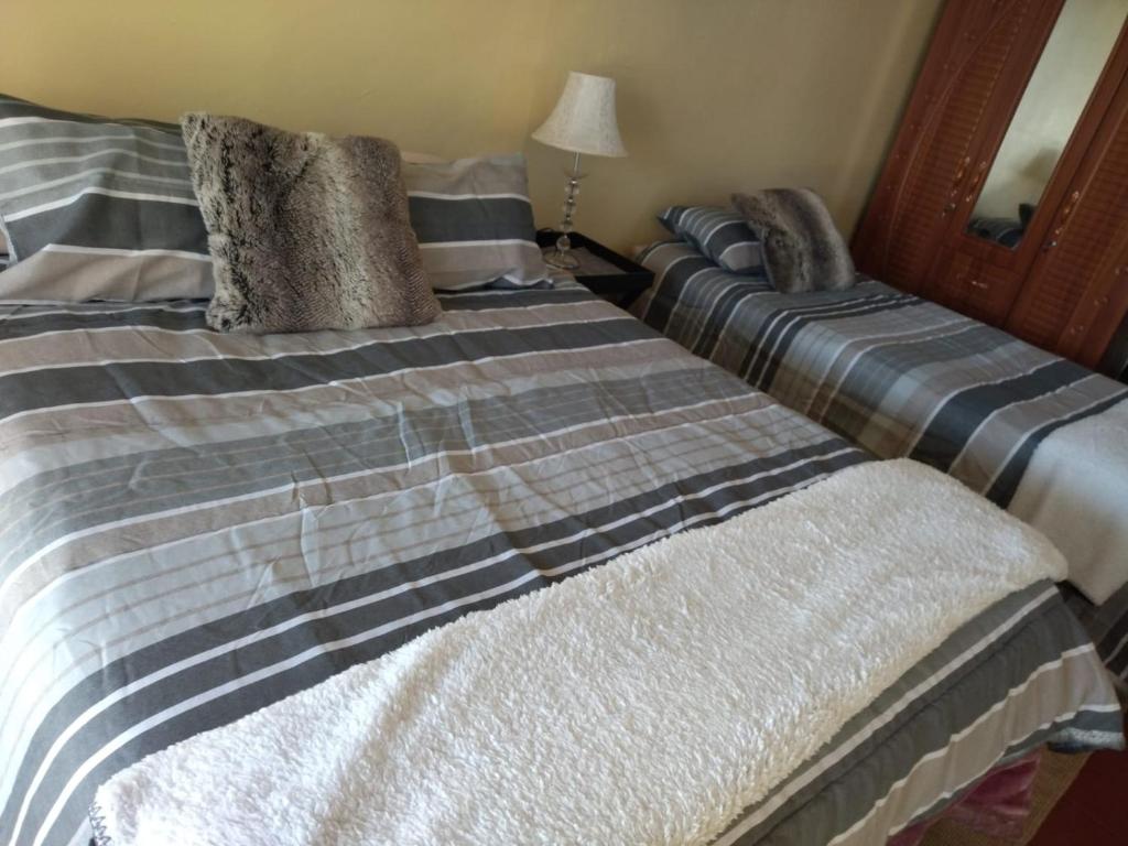 two beds sitting next to each other in a room at Rebanien2 Overnight Accommodation Double and Single bed in De Aar