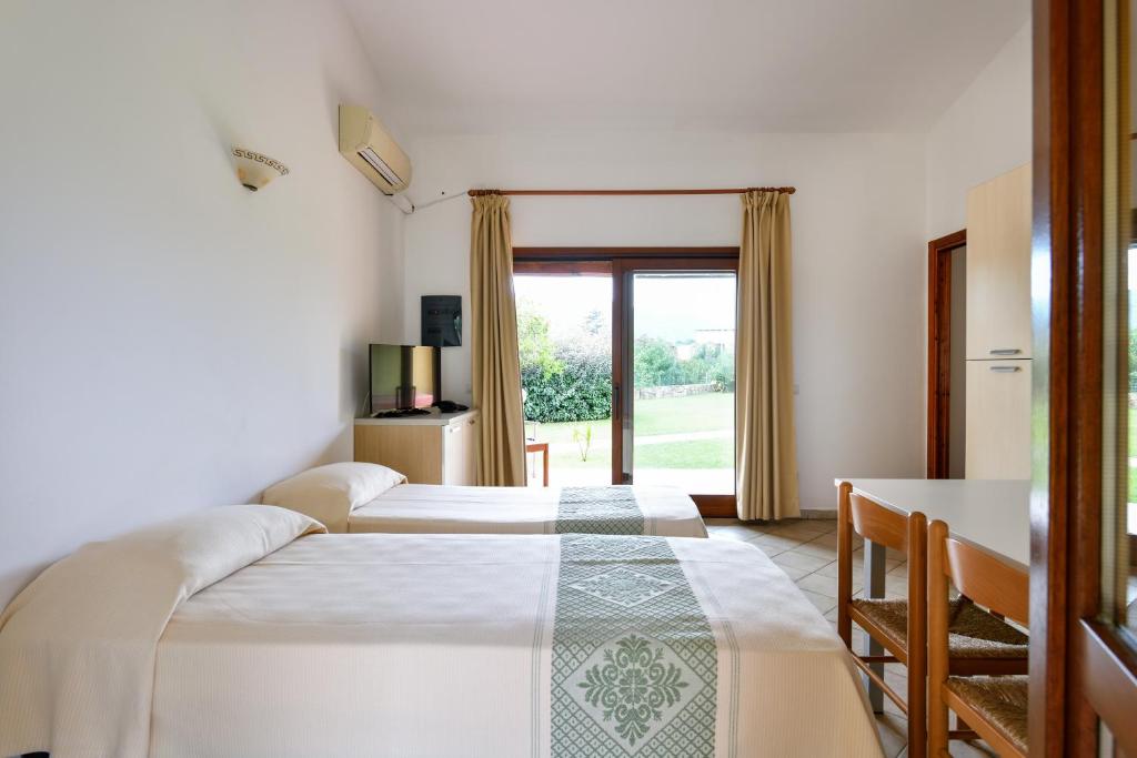 Postel nebo postele na pokoji v ubytování Hotel Baia Del Porto