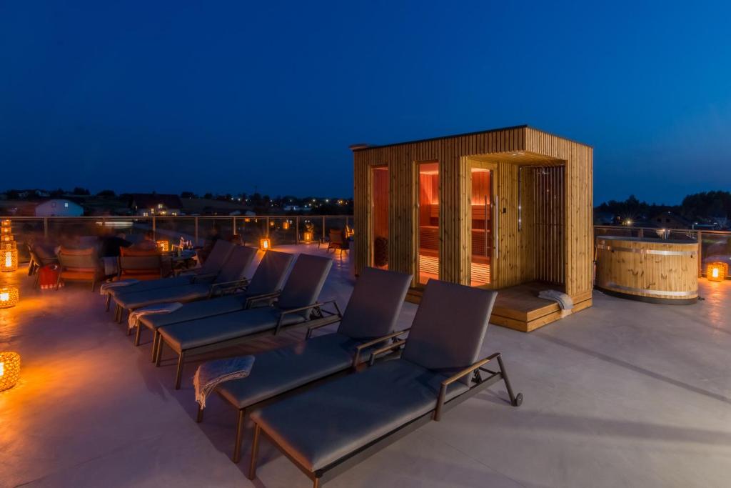 a group of chairs sitting on a roof at night at PORTAMENTY in Chłopy