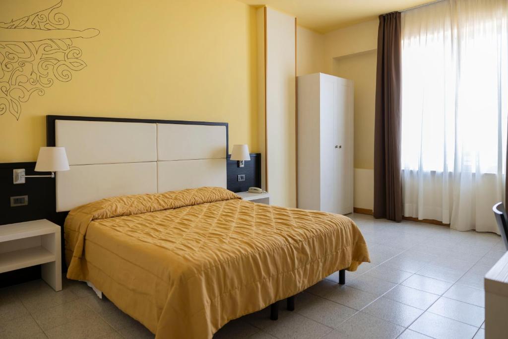 Postel nebo postele na pokoji v ubytování Hotel Villa Margherita