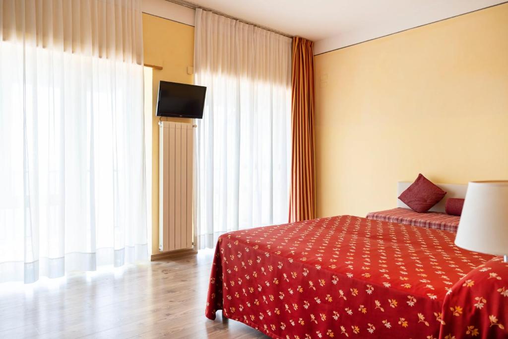 Postel nebo postele na pokoji v ubytování Hotel Villa Margherita