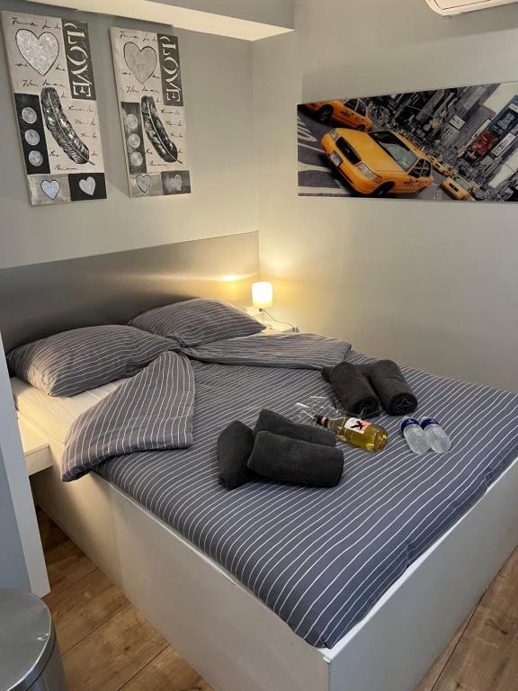 a bed with a blue and white striped bedspread and a car picture at City Center Studio Amsterdam in Amsterdam