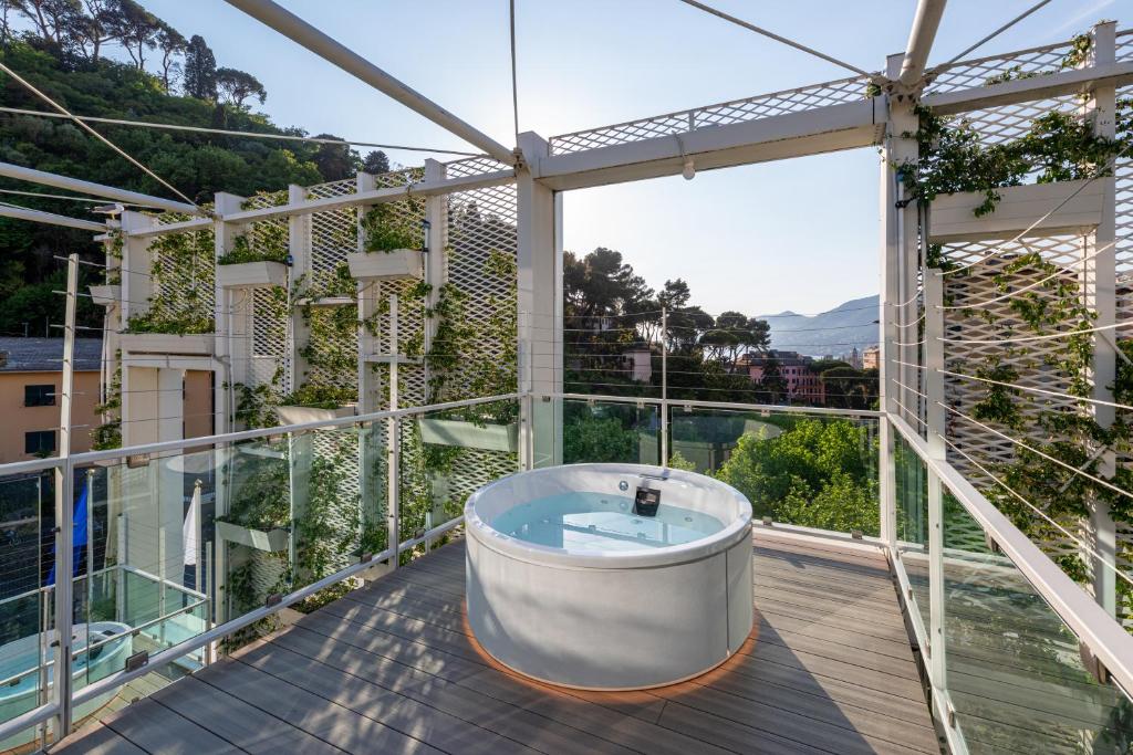 a hot tub on the balcony of a house at Carrick Hotel Camogli Portofino Coast in Camogli