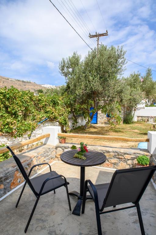 a patio with two chairs and a table with a table at Lakki Village in Aegiali