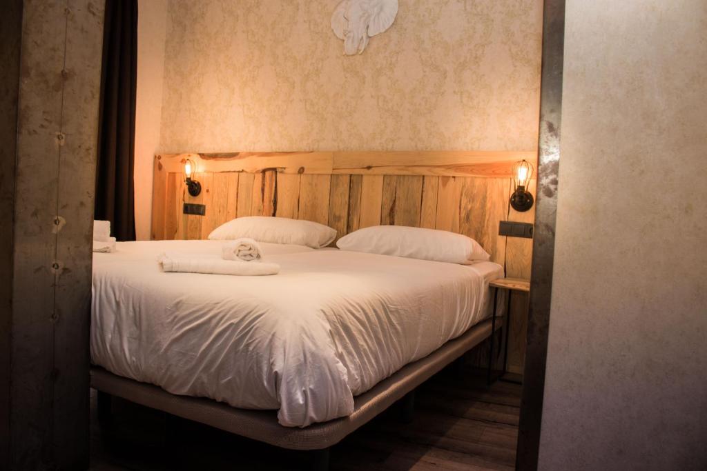 a bedroom with a large bed with white sheets at Black Swan the Penthouse in Seville